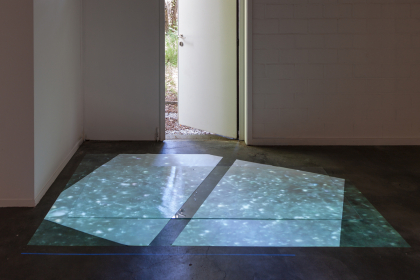 Outside-inside (2020) | video-installation | 03:10, color, HD, loop | 80 x 200 cm | glass, white pigment, oil, white paper, projection in Whitehouse Gym